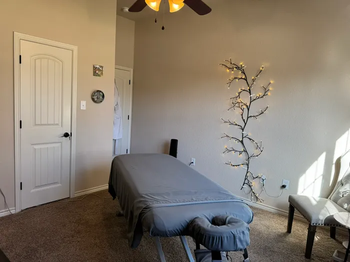 Massage room with a lit branch on the wall